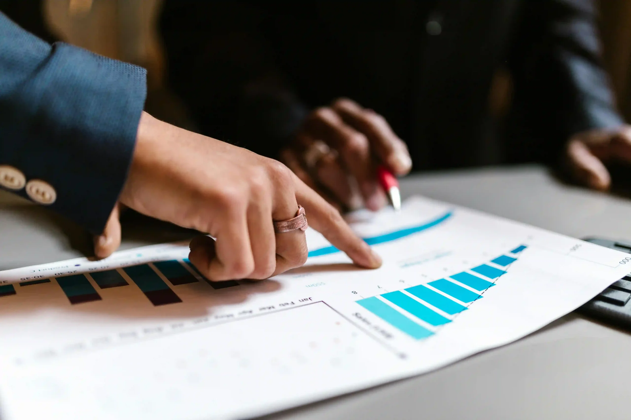 An EnforceMG Employee Goes Over an SEO Growth Chart with a New Client.